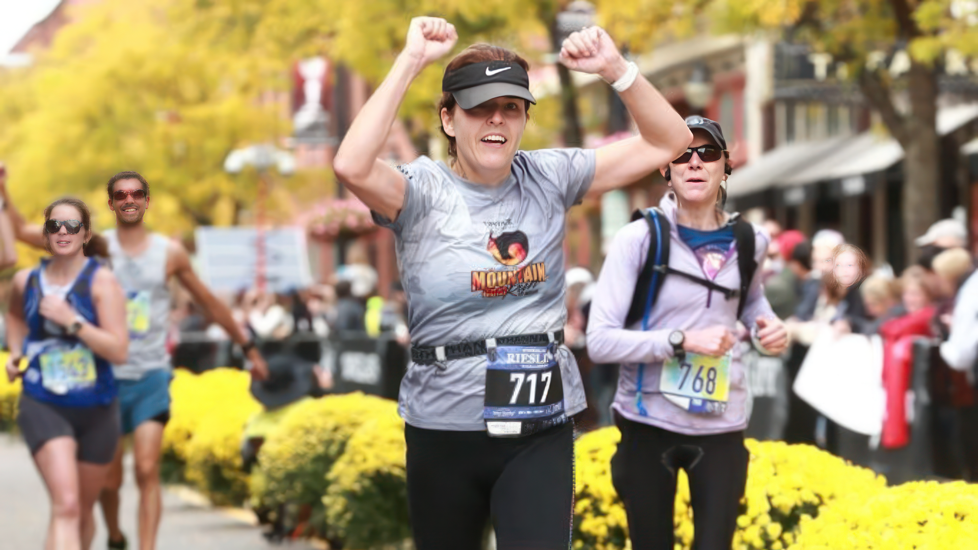 Runner crossing finish line arms raised